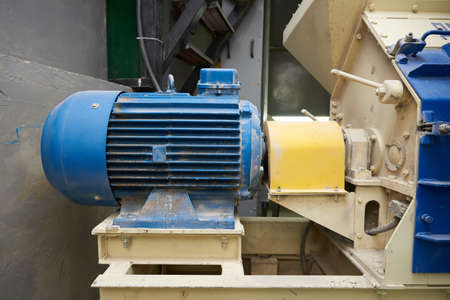 Large blue electric motor in the factory