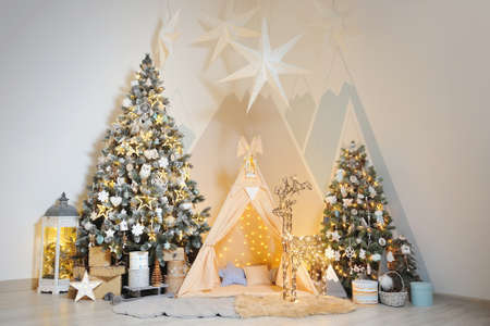 Playroom for children with Christmas decorations, gifts, tent and Christmas trees
