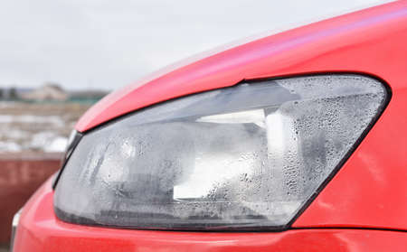Foggy headlight with condensation in a modern carの写真素材