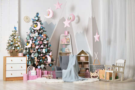 Christmas decorations with a Christmas tree in a bright childrens bedroomの写真素材