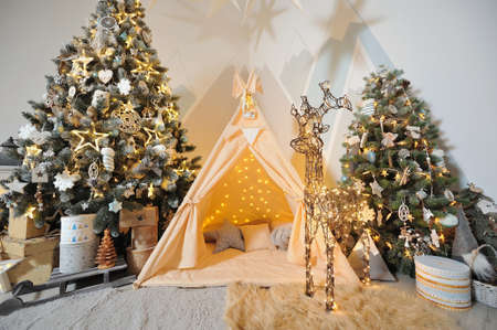 Playroom for children with Christmas decorations, gifts, tent and Christmas trees