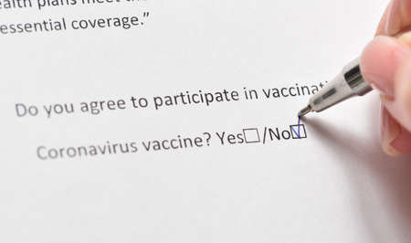 Refusal of vaccination against coronavirus signs a person, fearing side effectsの写真素材