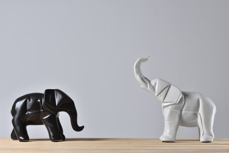 Statues of white and black elephants in geometry styleの写真素材