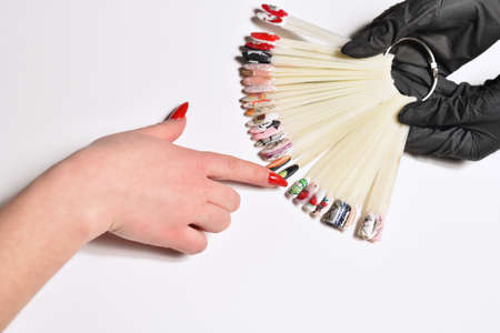 STARIY OSKOL, RUSSIA - JANUARY 25, 2021: Woman chooses color of nail polish at nail salonのeditorial素材