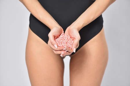 Young woman holding depilation wax in hands, body care and femininity concept