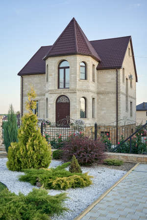 STARIY OSKOL, RUSSIA - AUGUST 22, 2020: Finished stone facade of a luxury private house with a towerのeditorial素材