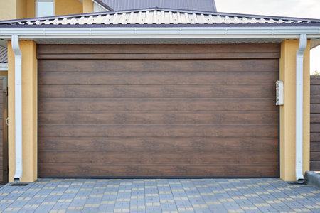 Facade of a private house with a plastic garage doorの写真素材