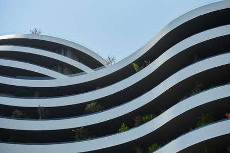Facade of a modern apartments building in europe with plants