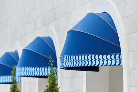 Exterior blue round awning mounted in archの写真素材