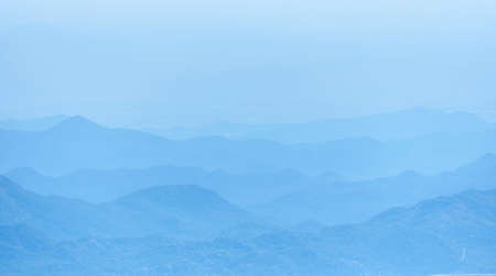 Mountain range silhouette in a blue hazeの写真素材