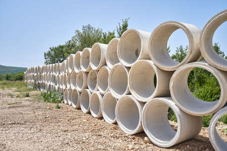 Stack of drainage concrete pipe for septic tanks and wells.の写真素材