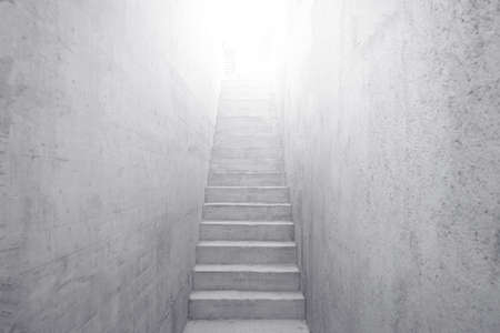 Concrete staircase leading up to bright light.の写真素材