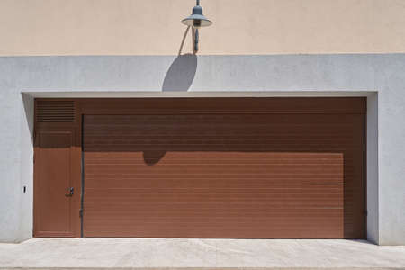 Wide rolling garage door with door.の写真素材