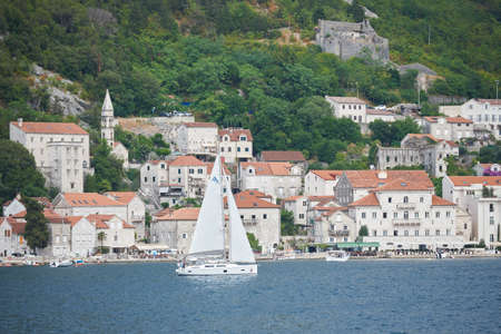 PERAST, MONTENEGRO - JULY 20, 2021: Sailing yacht on the background of an old European cityのeditorial素材