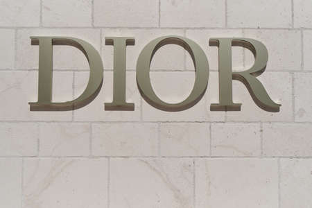 TIVAT, MONTENEGRO - JULY 15, 2021: Dior signboard on the wall of a branded boutiqueのeditorial素材