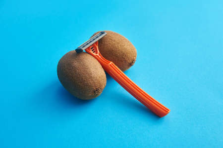 Hairy kiwi and razor, male depilation conceptの写真素材