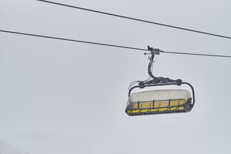 Ski lift cabin without people in the snowfall in ski resort