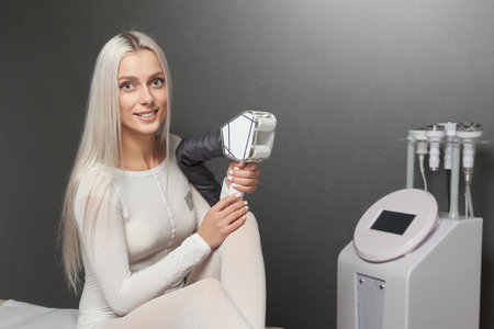 Young Woman showing LPG Massage slimming machineの写真素材