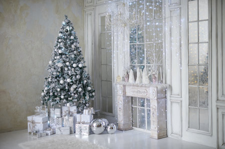 Cozy christmas interior of the living room with frosted christmas tree and white giftsの写真素材