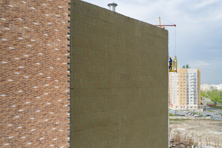 Construction of an apartment building with external wall Insulationの写真素材