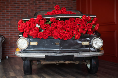 Retro car with red flowers of roses for interior