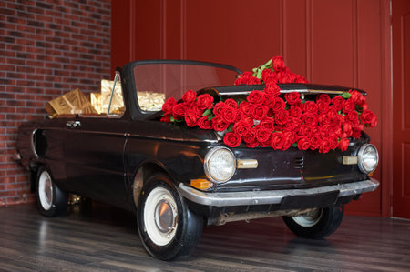 Retro car with red roses in the interior for decoration