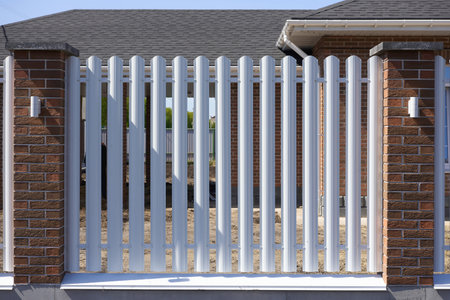 Modern white picket fence at a residential houseの写真素材
