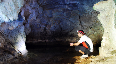 man exploring a caveの写真素材