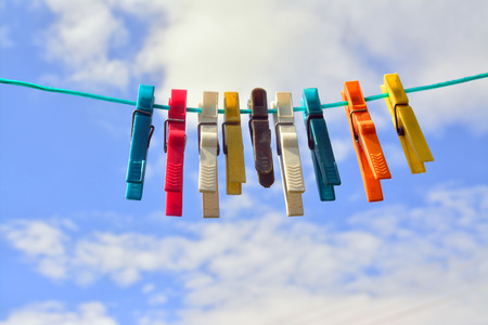 plastic clothespins on the wireの写真素材