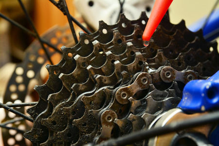 grease lubricating a bicycle gears cogwheelの写真素材