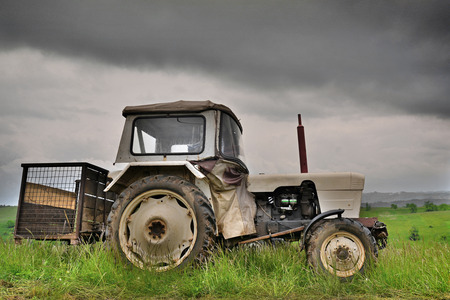 Tractor on field at sunset after plowing