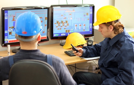 Industrial workers in control roomの写真素材