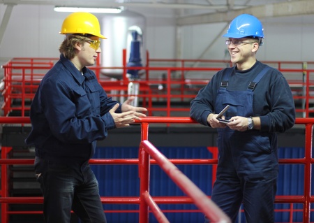 Workers talking in a factoryの写真素材