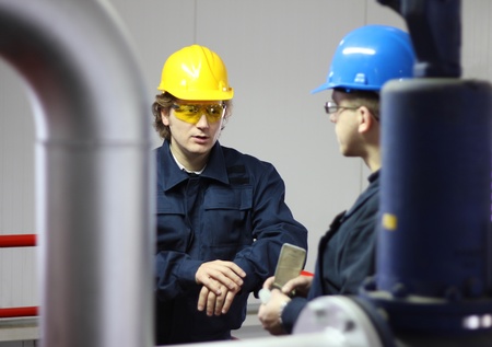 Workers talking in a factoryの写真素材