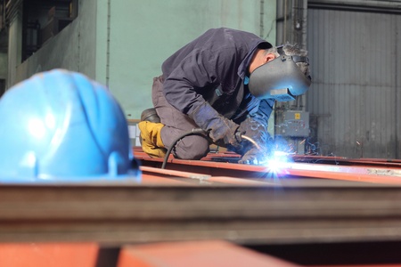 Welder at work in metal industry