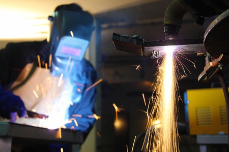 Steel Workers welding, grinding, cutting in metal industry