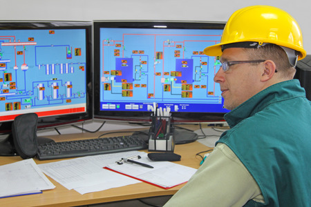 Industrial worker in control room Industrial worker in control room