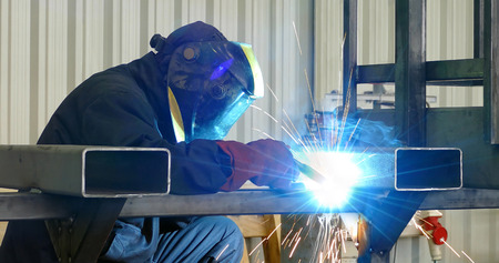 Steel worker welding, lots of sparks in metal industryの写真素材