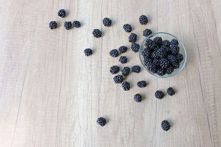 Fresh blackberries on wooden background, close up of berries juicy ripe fruitの写真素材