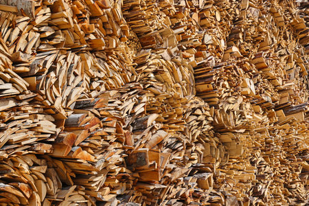 Pile of boards and bark from spruce tree in wood industry for further processing in the sawmill....