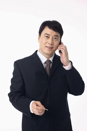 Businessman talking on the phone, hand holding stylusの写真素材