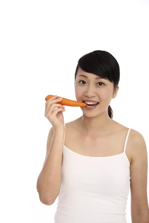 Woman eating carrotの写真素材