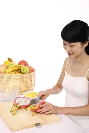Woman cutting dragon fruitの写真素材