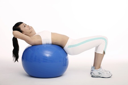Woman exercising on fitness ballの写真素材
