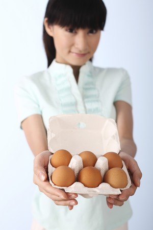 Woman with a tray of eggsの写真素材