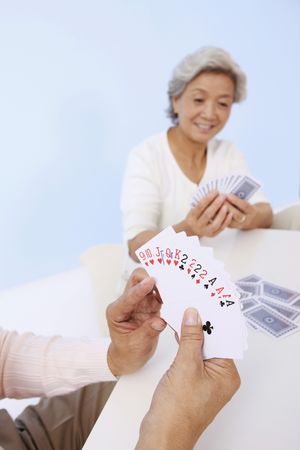 Senior man and senior woman playing cardsの写真素材