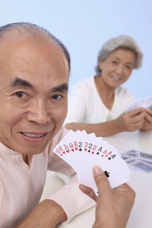 Senior man showing his cardsの写真素材