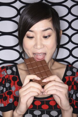 Woman holding chocolate barの写真素材