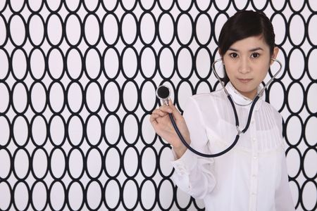 Businesswoman with a stethoscopeの写真素材