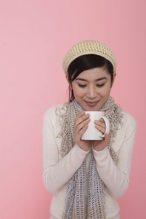 Woman enjoying a hot cup of teaの写真素材